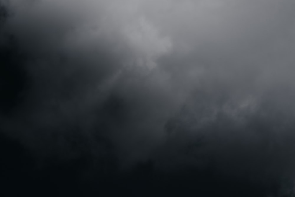 a plane flying through a dark cloudy sky