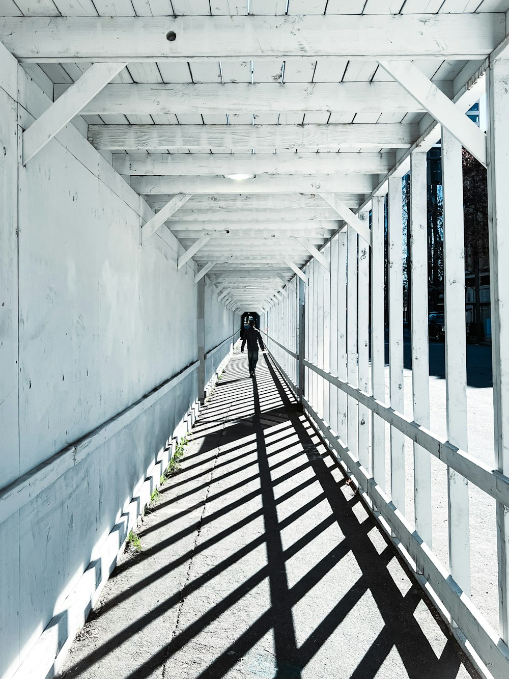 a person is walking down a long walkway