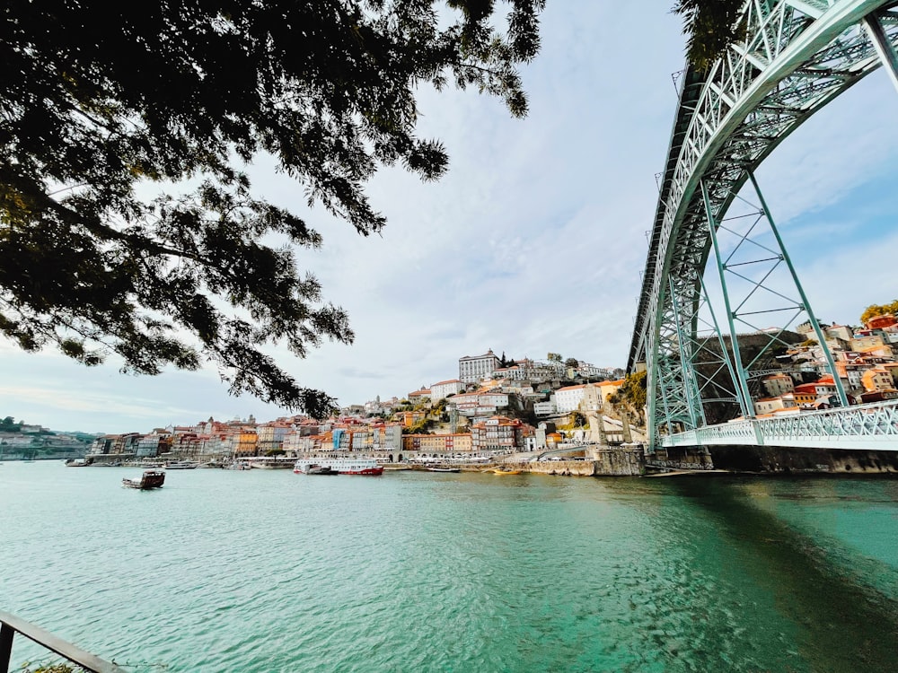 a bridge over a river with a boat in the water