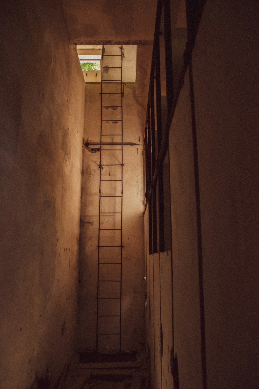 a ladder up to a window in a dark room