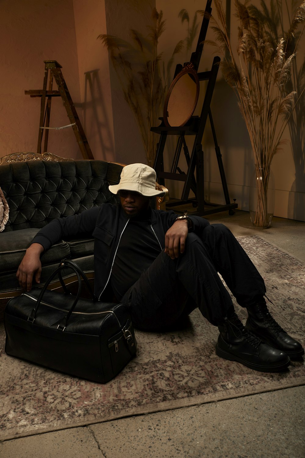 a man sitting on the floor with a suit case