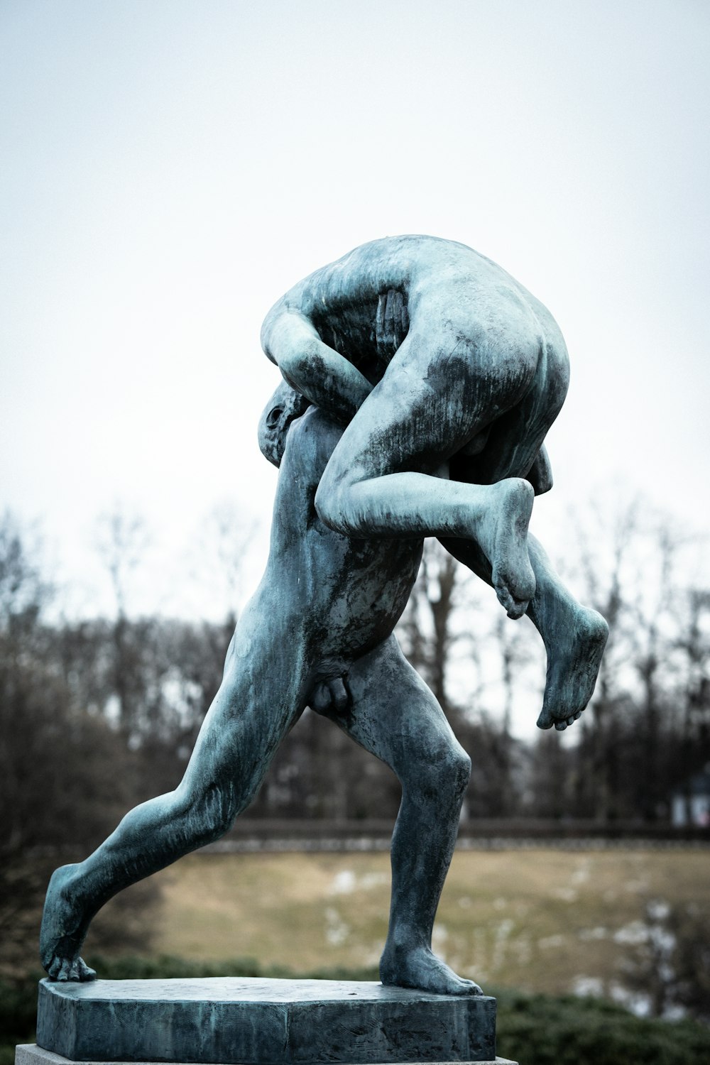 a statue of a man wrestling with another man