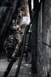 a man sitting on a bench next to a pile of hay