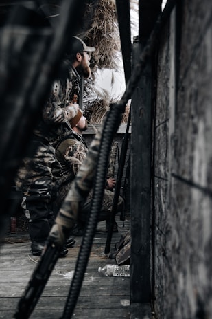 a man sitting on a bench next to a pile of hay