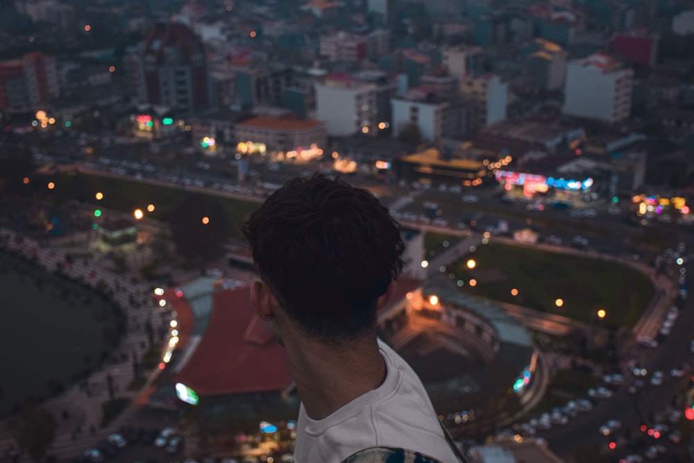 a man standing on top of a tall building