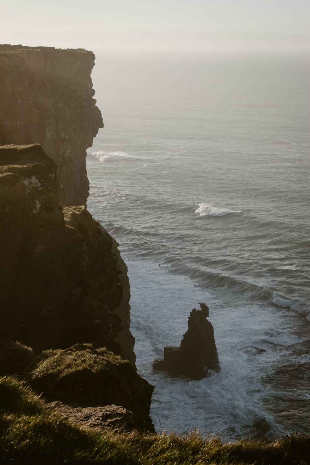 a rocky cliff overlooks a body of water