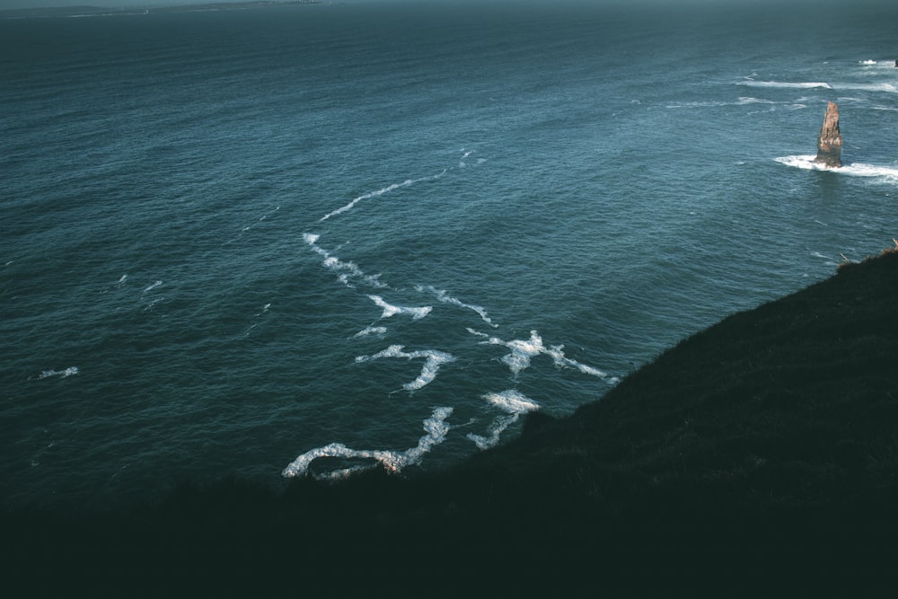 a large body of water near a cliff