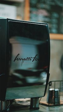 A sleek robotic coffee machine preparing a latte.