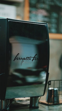 A sleek black and rose gold jet cleaner machine displayed on a polished metal surface.