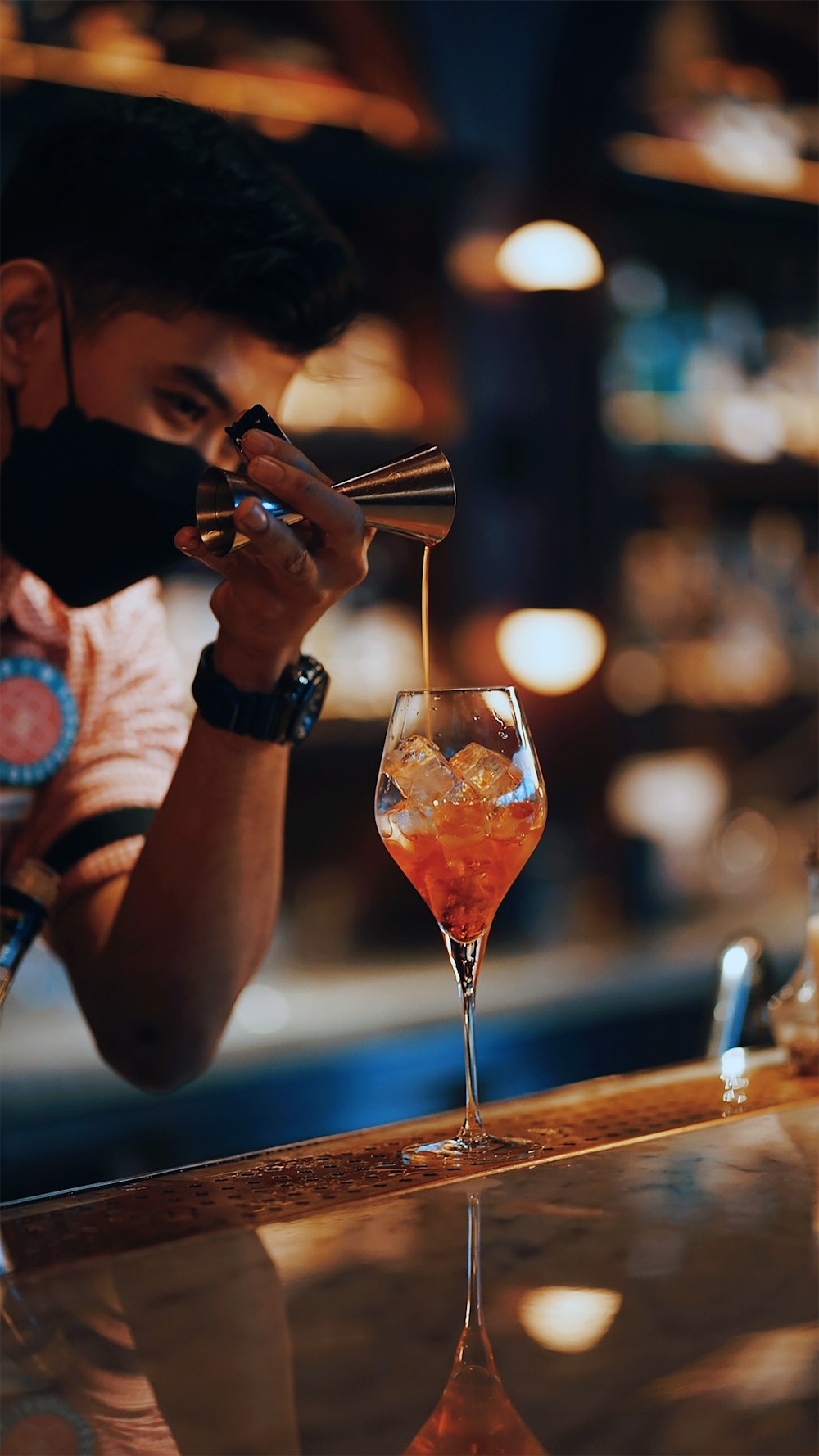 a man sitting at a bar with a drink in front of him