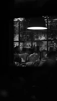 Shadowy bar scene featuring a bartender preparing a drink, with dark forest green backdrop and rich gold highlights.