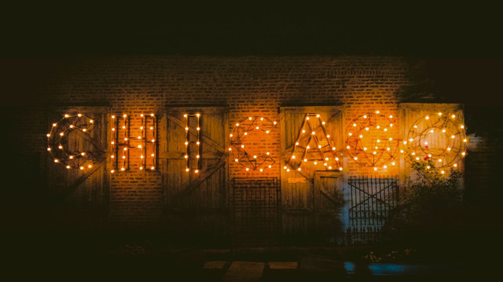 a brick wall with lights that spell out the word march