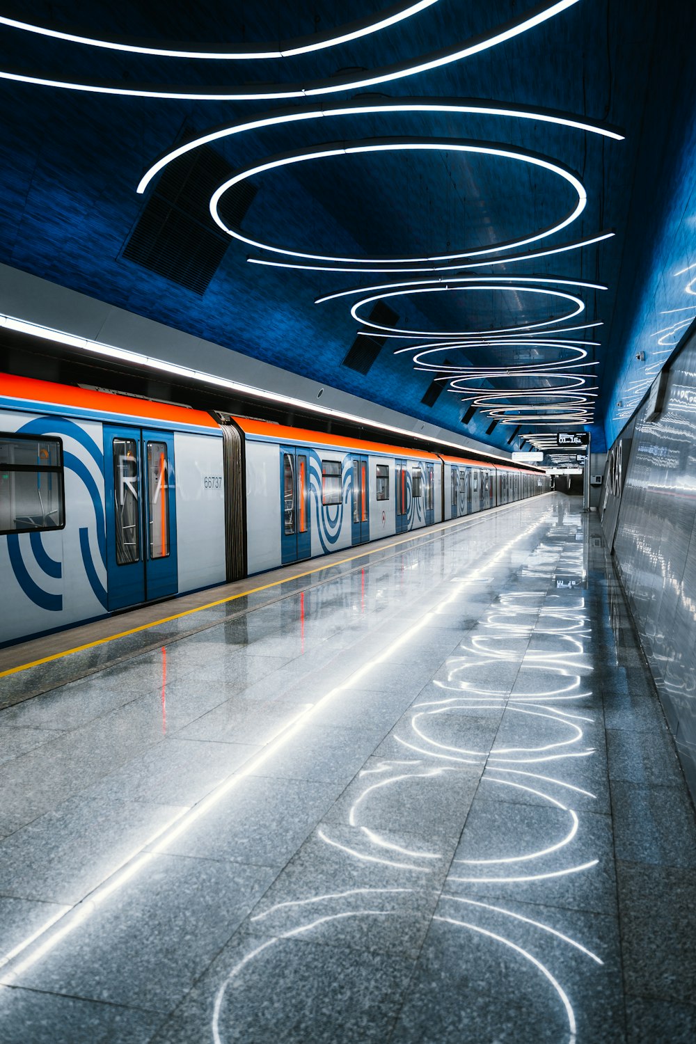 a subway train pulling into a train station