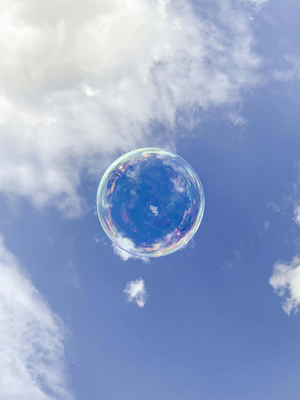 a soap bubble floating in the air on a sunny day