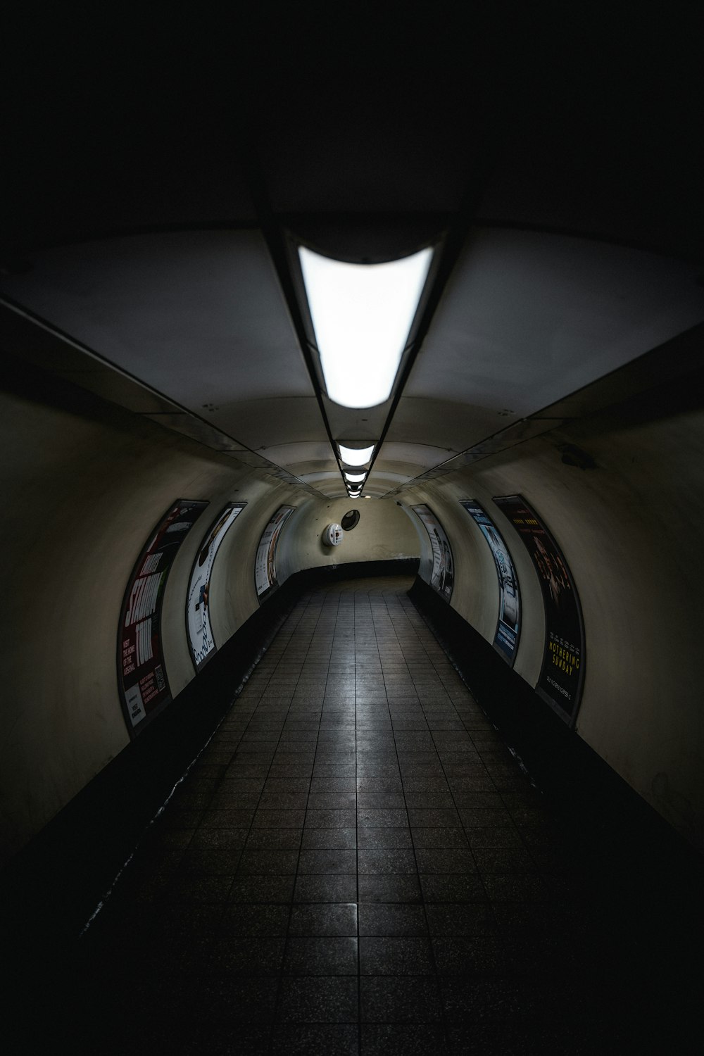 a long hallway with a skylight at the end of it