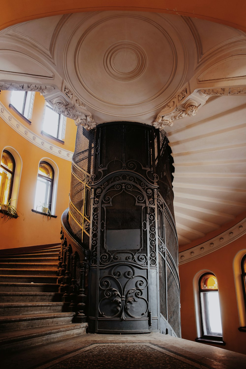 a spiral staircase in a building with a circular ceiling