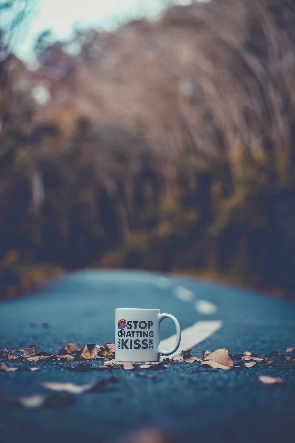 a cup of coffee sitting on the side of a road