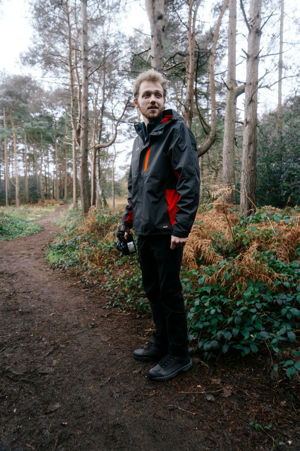 a man standing in the middle of a forest