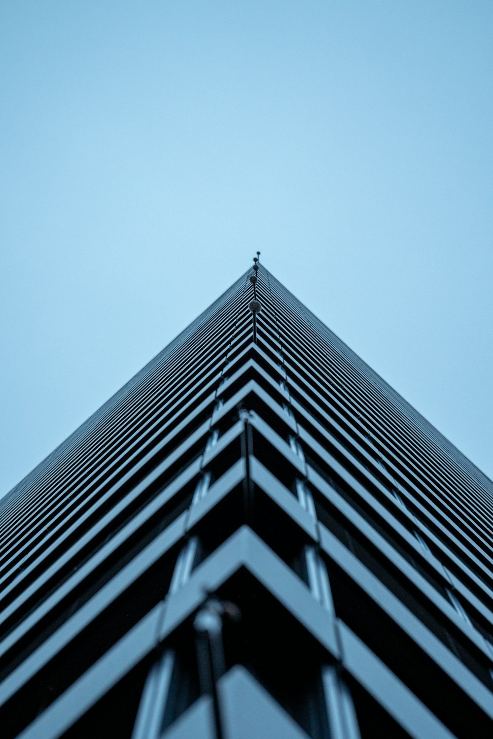 a tall building with a sky in the background