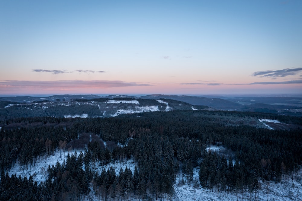 a view of a snowy mountain at sunset