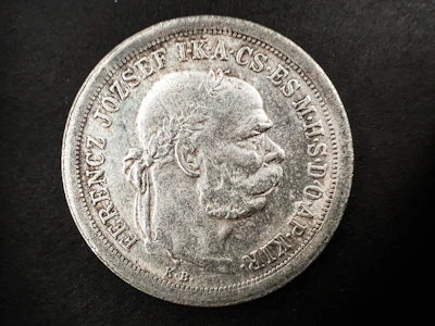 An ancient bronze coin showing a worn but detailed profile of a historical figure.