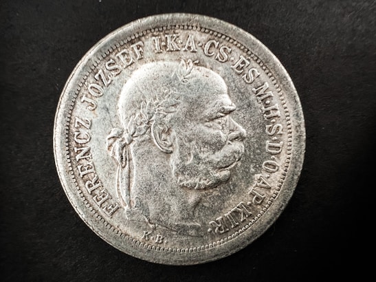 Side view of the silver coin highlighting its thickness and aged texture.