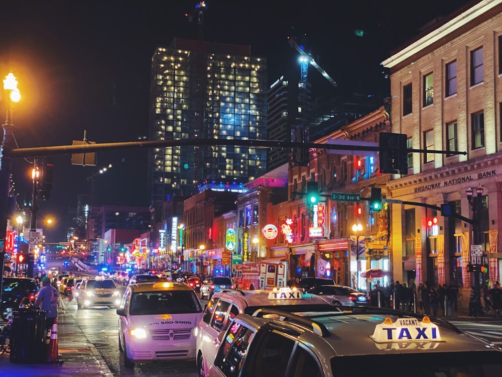 a city street filled with lots of traffic at night