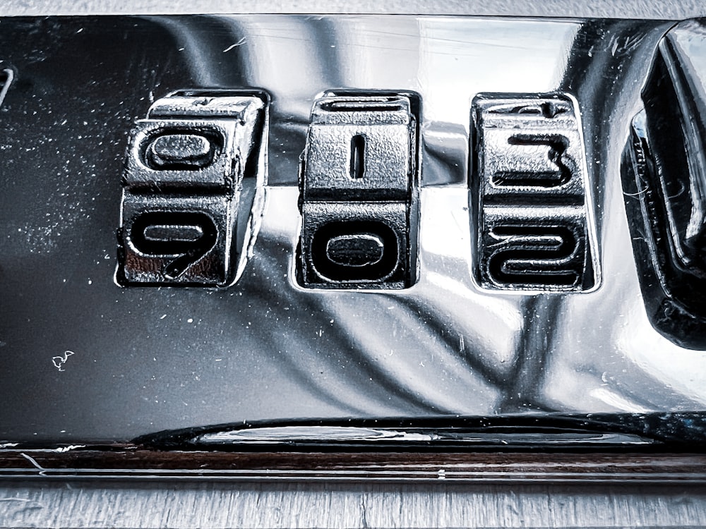 a close up of a metal plate with numbers on it