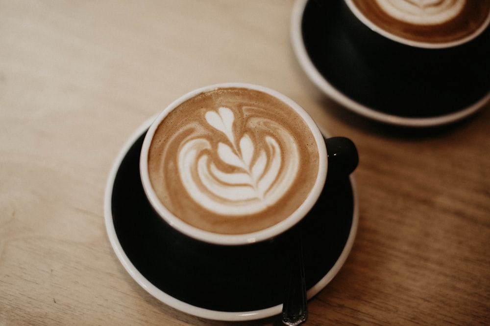 two cups of coffee on a wooden table