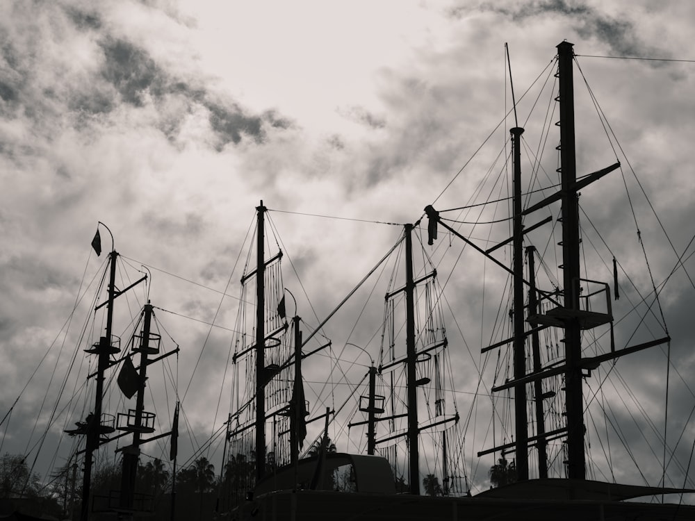 a black and white photo of several masts of a ship