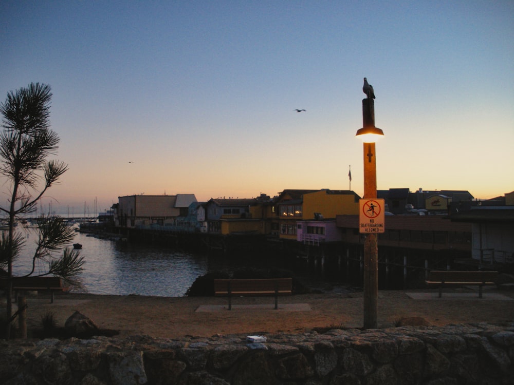 a street sign in front of a body of water