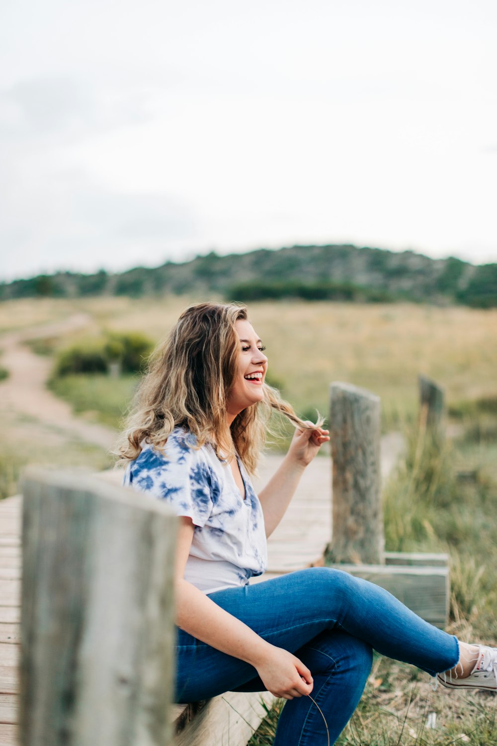 a woman sitting on a bench eating a piece of food