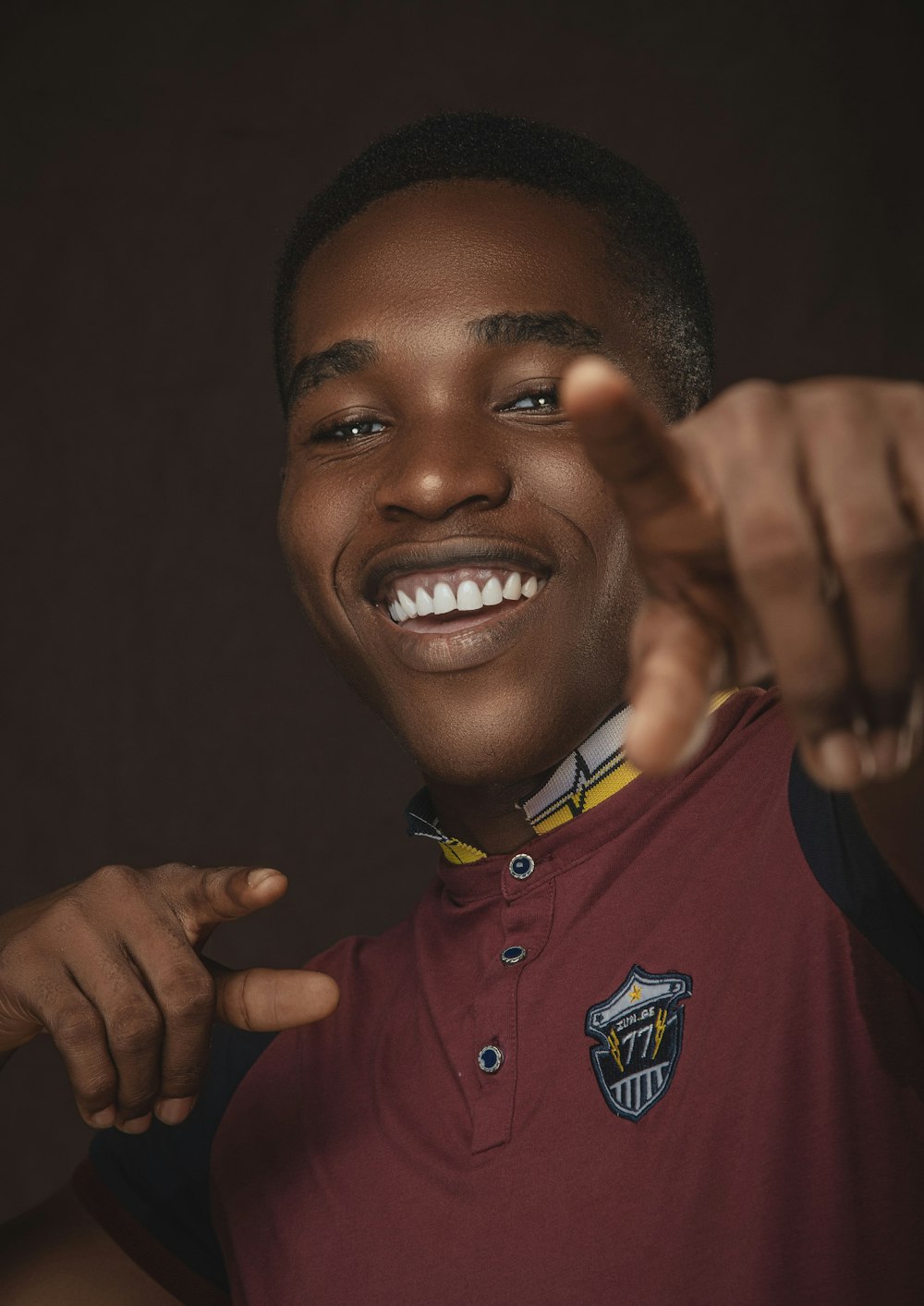 a young man making a hand sign with his fingers