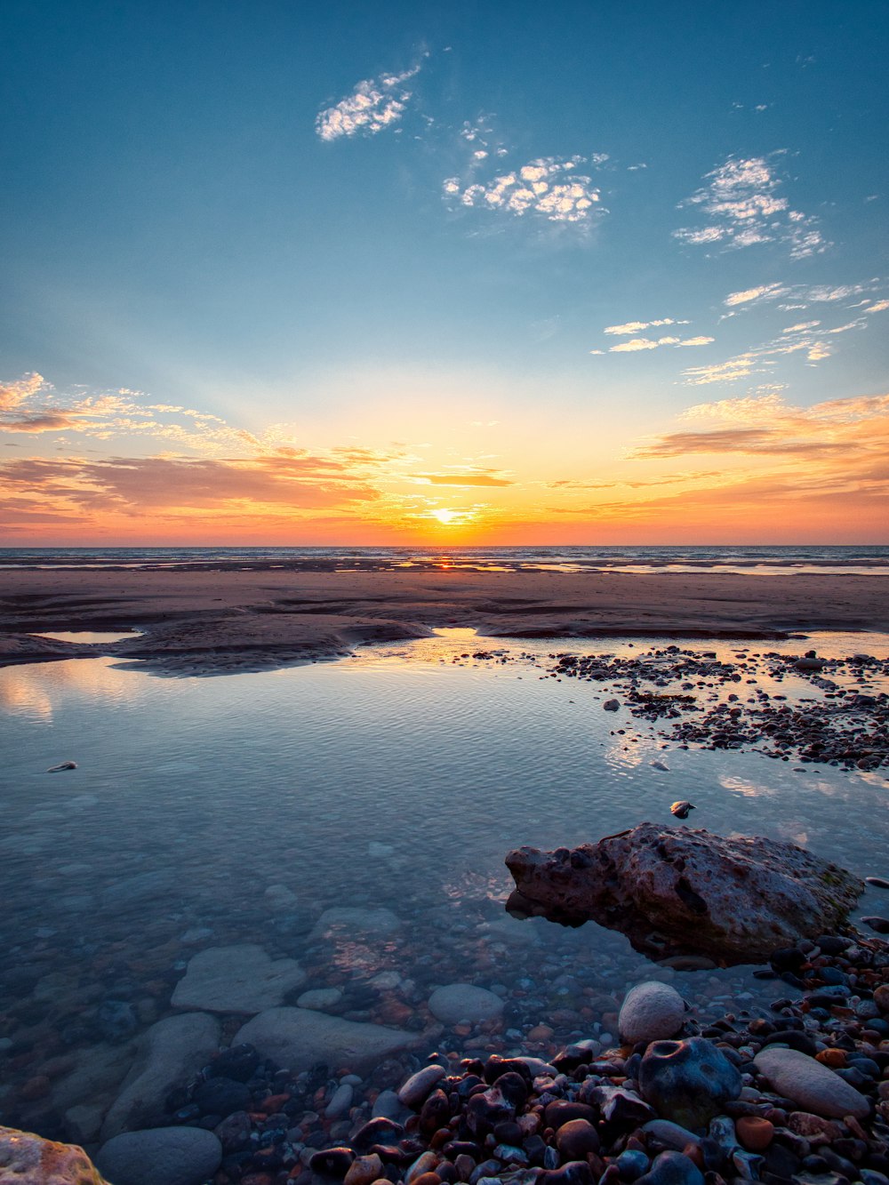 the sun is setting over a body of water