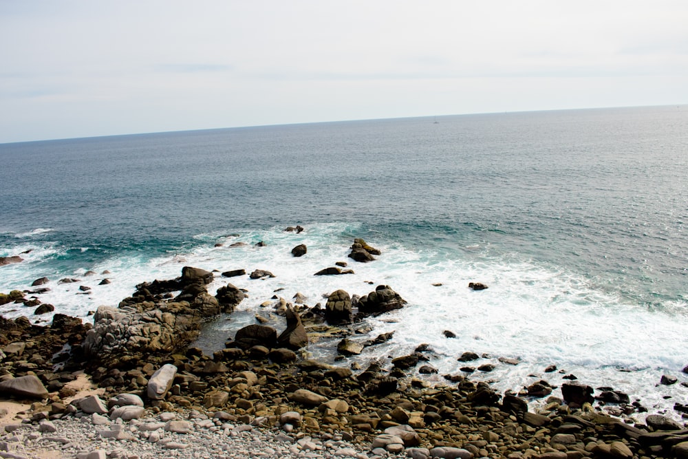 a view of the ocean from a rocky shore