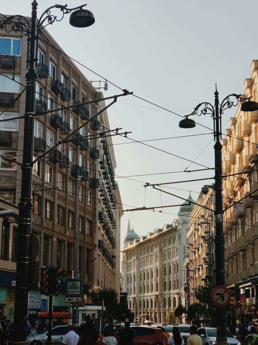 a city street filled with lots of traffic and tall buildings