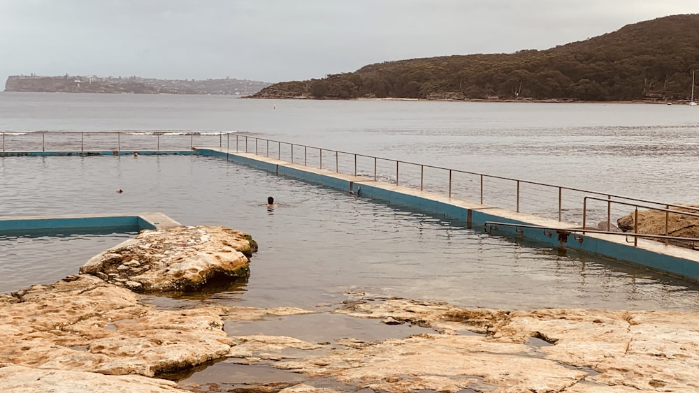 a large body of water next to a rocky shore