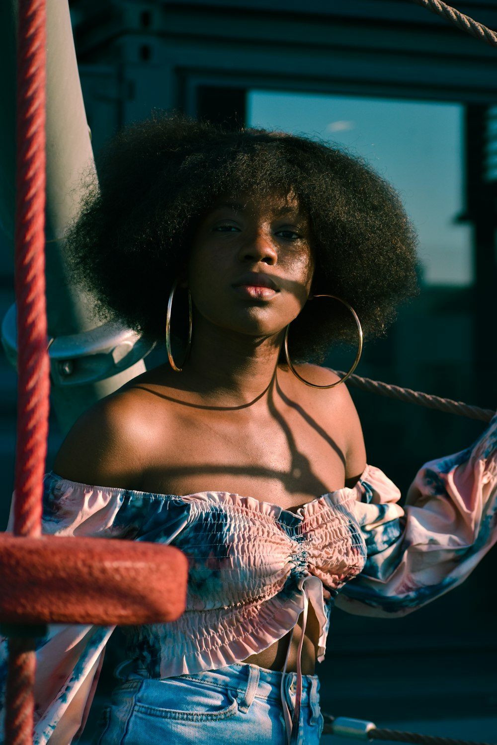 a woman with an afro standing on a boat