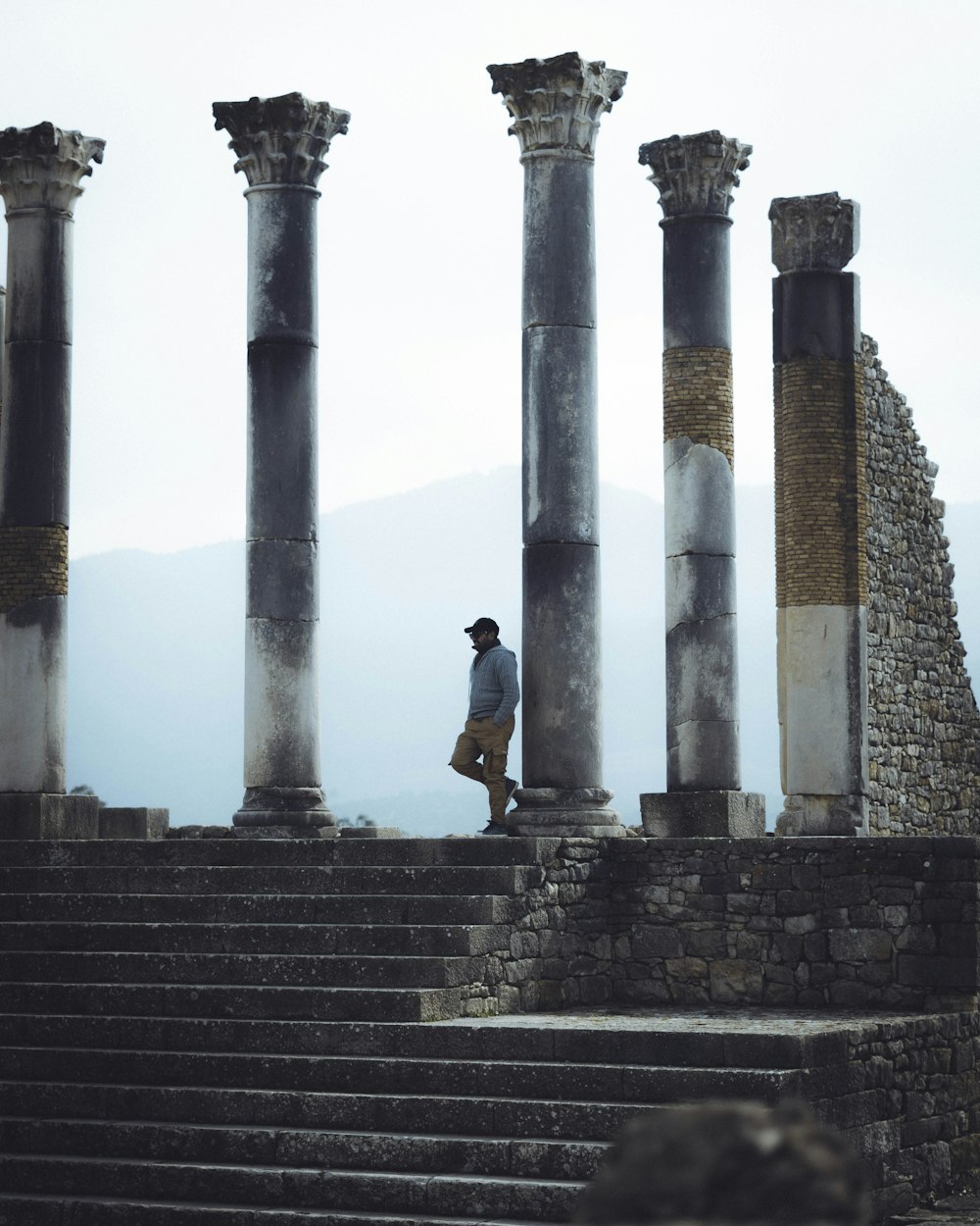 a man standing on top of a set of stone steps
