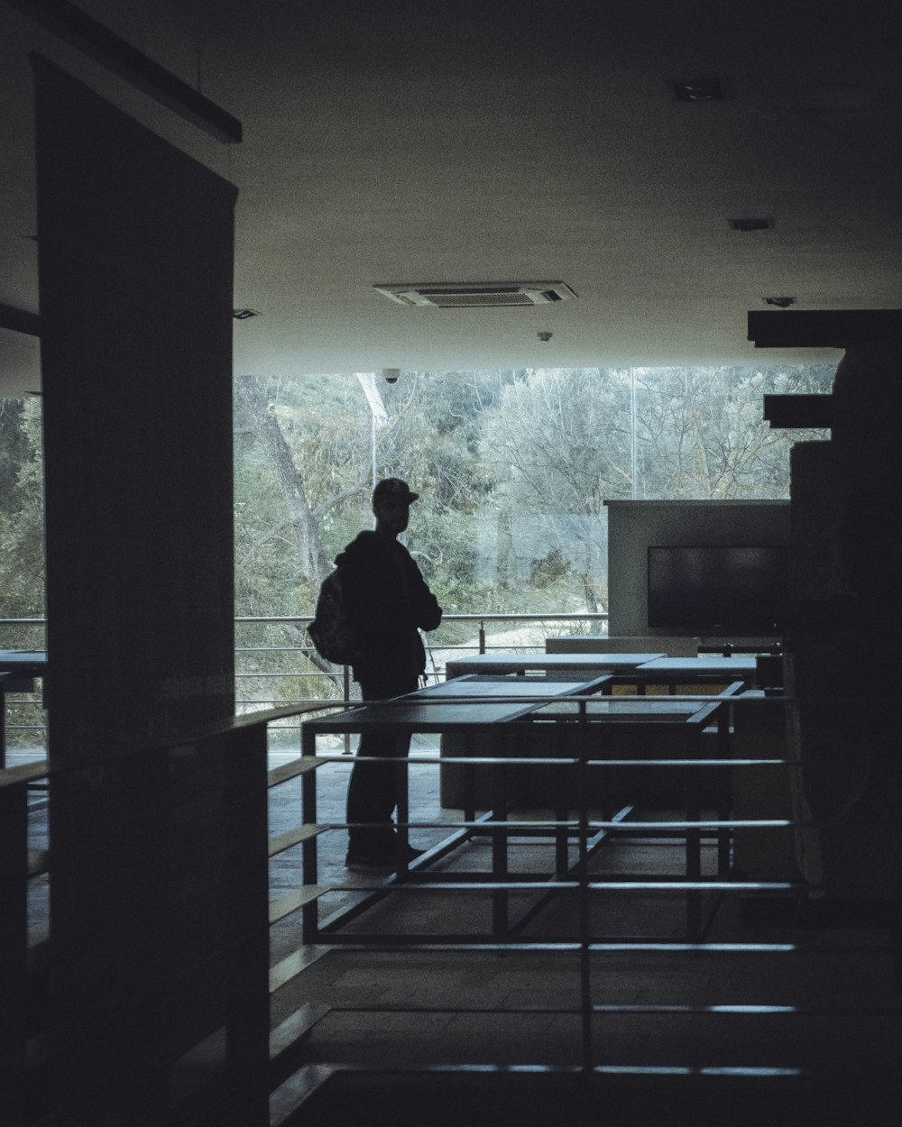 a person standing in a room with tables