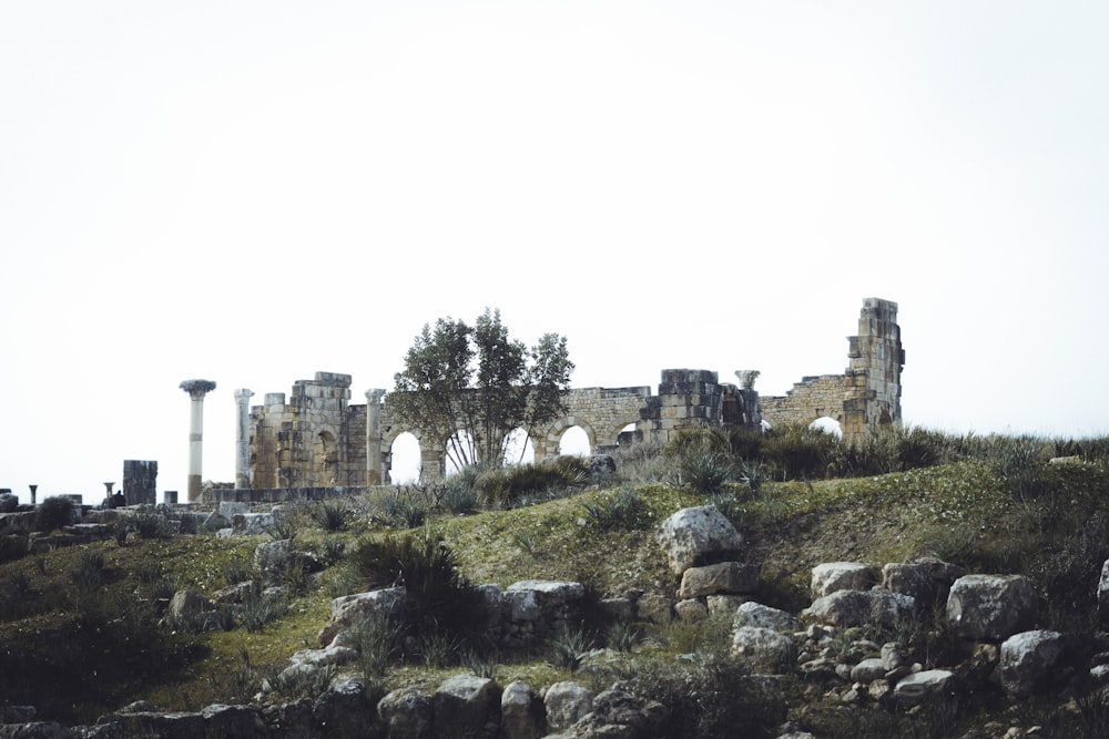 the ruins of a building on the side of a hill