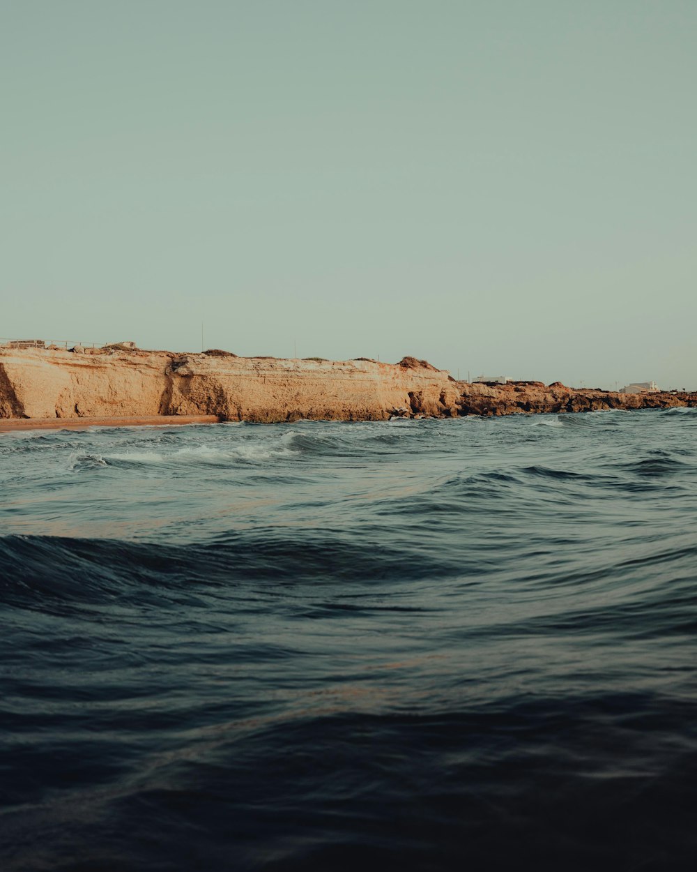 a man riding a surfboard on top of a wave in the ocean