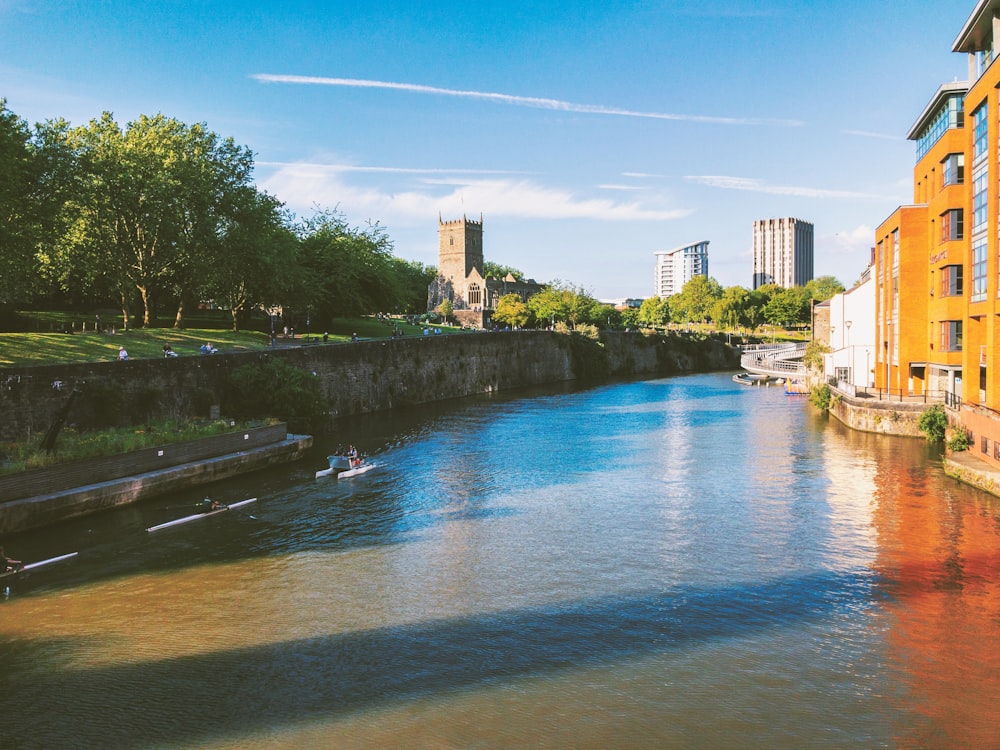 a river running through a city next to tall buildings