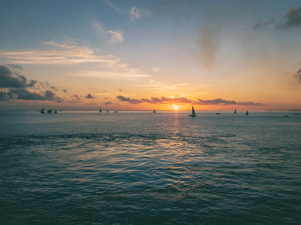 a group of boats floating on top of a large body of water