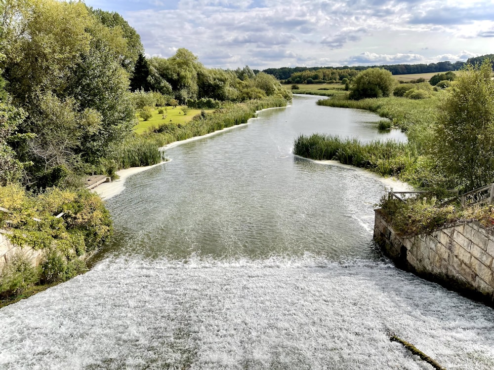 a river running through a lush green countryside