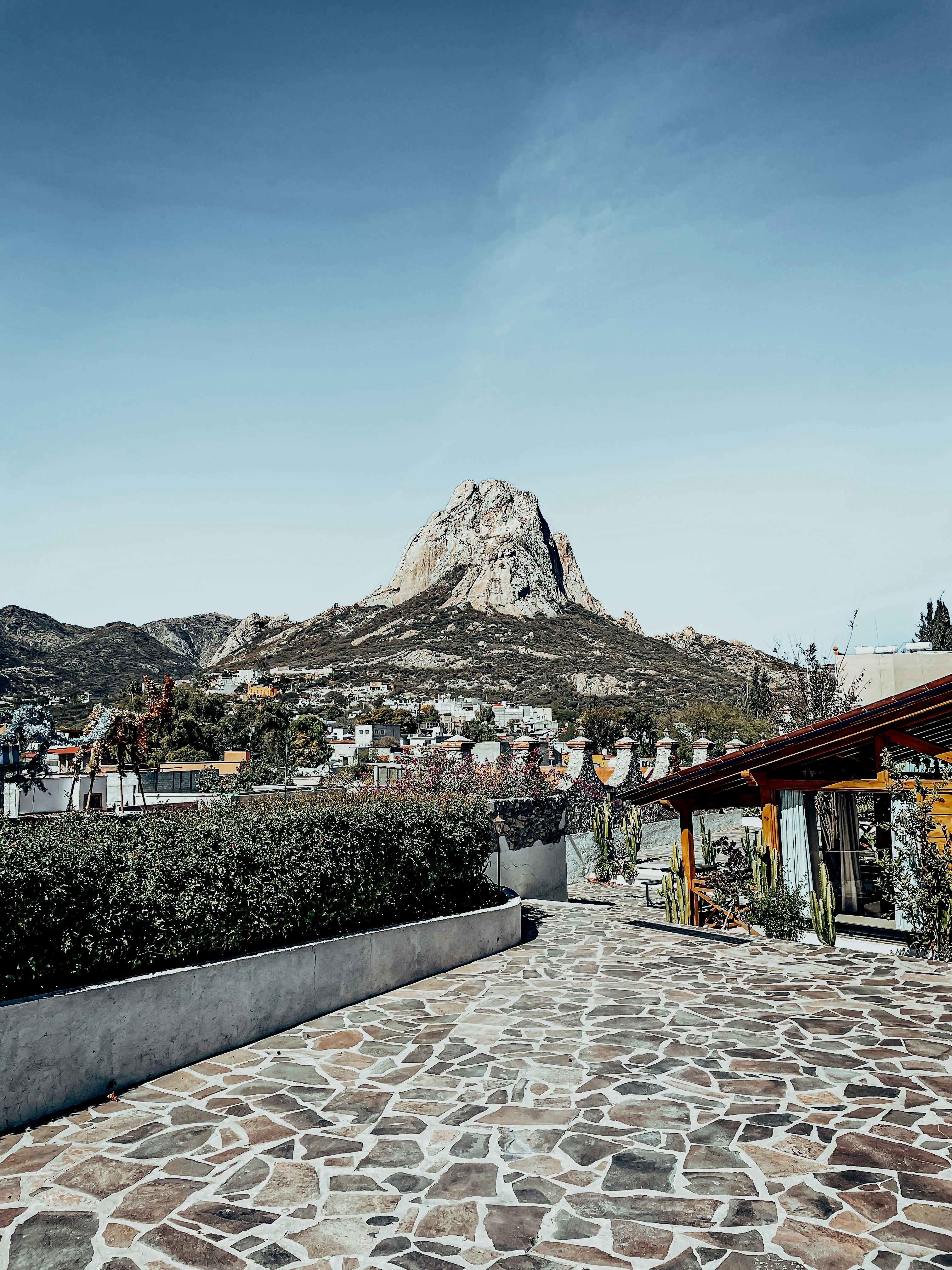 a stone walkway with a mountain in the background