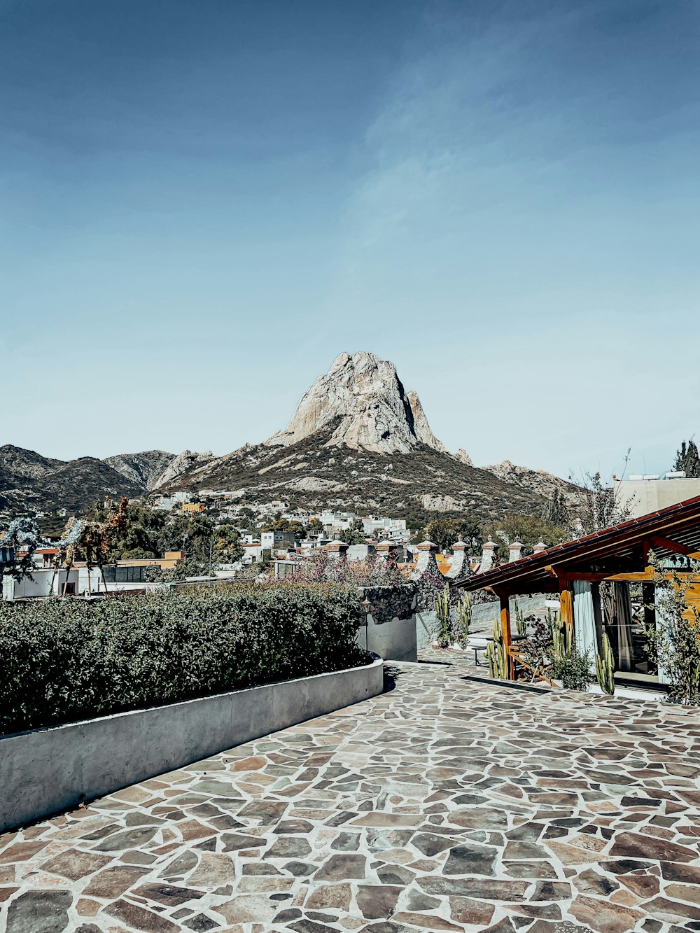 a stone walkway with a mountain in the background