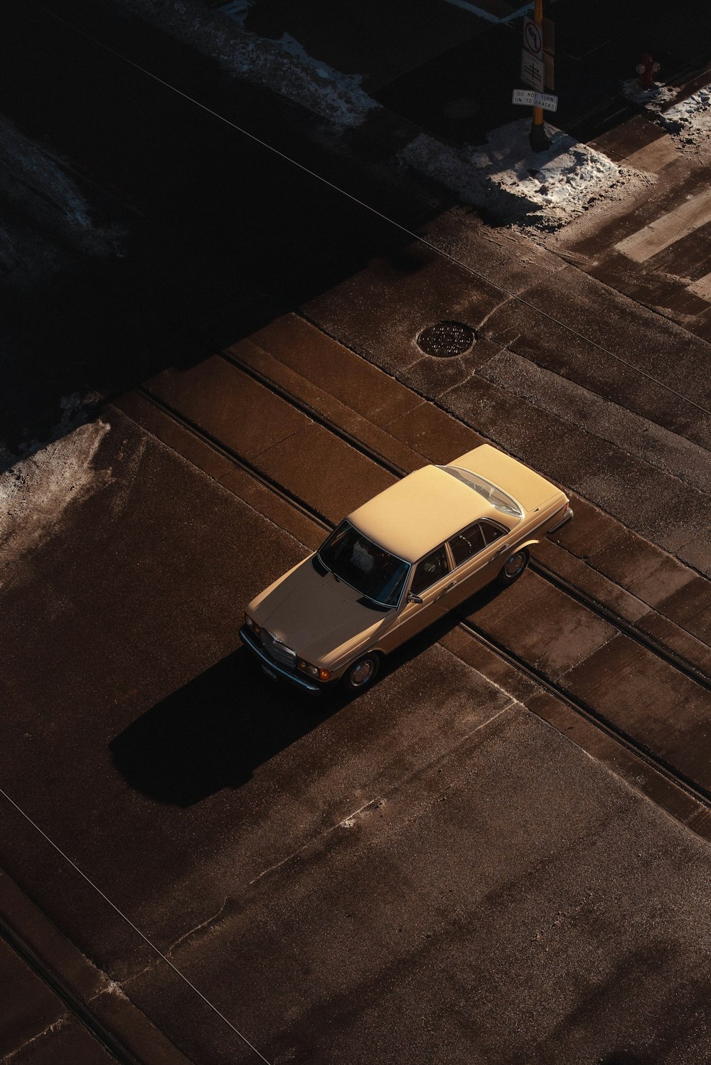 an old car is parked on the side of the road