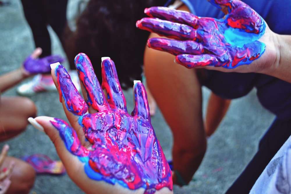 a group of people with painted hands holding something
