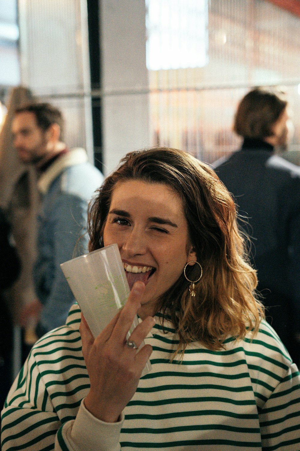 a woman holding a piece of paper in her mouth